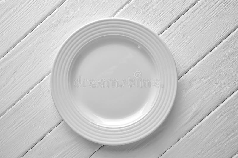 White ceramic plate close-up on painted wood background stock photo